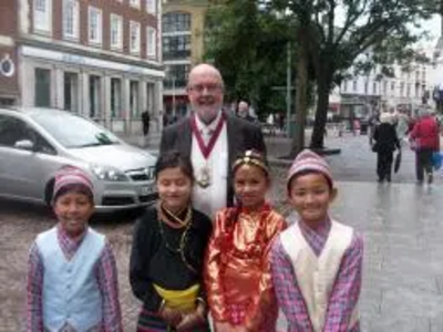 Tom McNeice and children in Nepali dress in Folkestone Town Centre