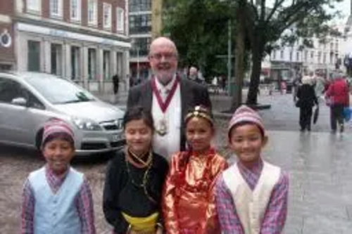 Tom McNeice and children in Nepali dress in Folkestone Town Centre