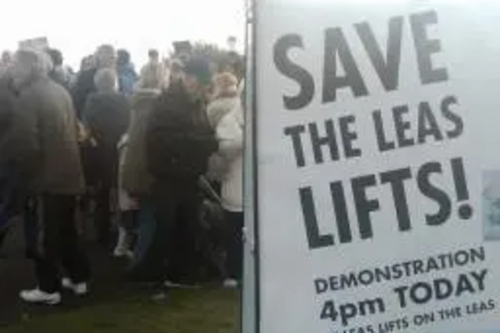 Save the Leas Lift campaign poster and demonstrators