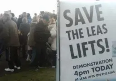 Save the Leas Lift campaign poster and demonstrators