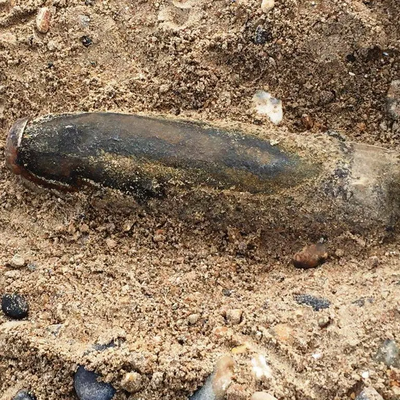 Unexploded WW2 shell (UXB) on beach