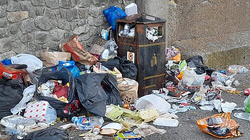 Over-run / overflowing bin and scattered litter and bin bags