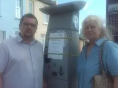 Sandgate and Folkestone West County Councillor Tim Prater and Sandgate Parish Councillor Ann Rimmer by the newly installed pay and display machine at Sandgate's Castle Road Car Park