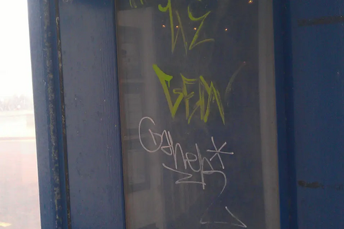 Graffiti on bus stop display board