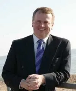 Peter Carroll standing on beach