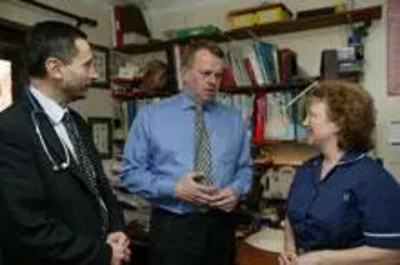 Peter Carroll talking with a local Doctor and Nurse