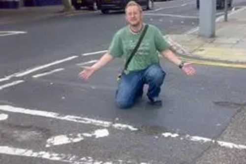 Gary Fuller with pot holes at the junction of Bouverie Road West and Christchurch Road