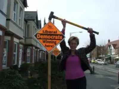 Lynne Beaumont with "Winning Here" garden poster