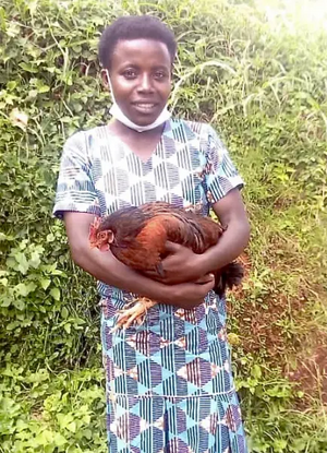 Sabina in new dress holding chicken