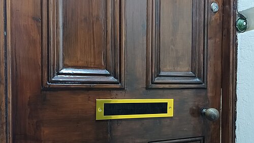 Wooden front door with gold letterbox / draught excluder