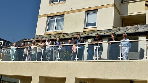 Tim Prater with Homevale House owners, tenants and residents on the newly completed balcony.