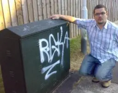 Tim Prater by graffiti on cable phone junction box