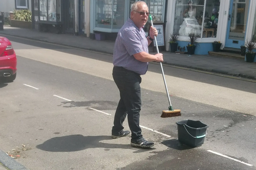 Kurt Stephens sweeping up in Sandgate High Street after rubbish collection