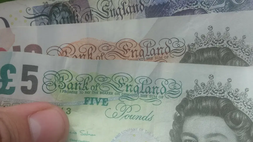 Money / banknotes (pounds sterling) in hand