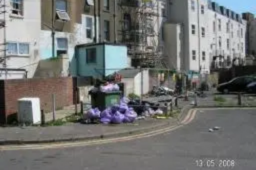 Rubbish, full bin and dumped washing machine