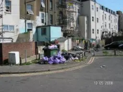 Rubbish, full bin and dumped washing machine