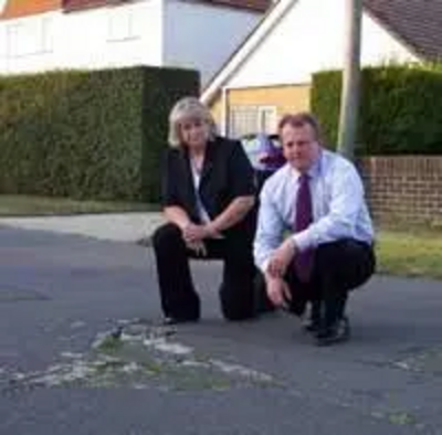 Ann Birchmore and Peter Carroll on an unadopted road in Littlestone