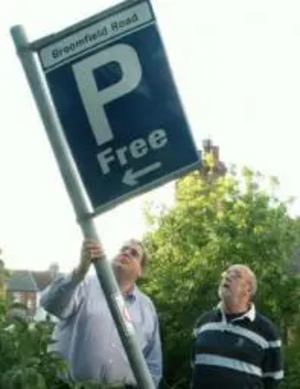 Tom McNeice and Darren Briddock with broken parking sign